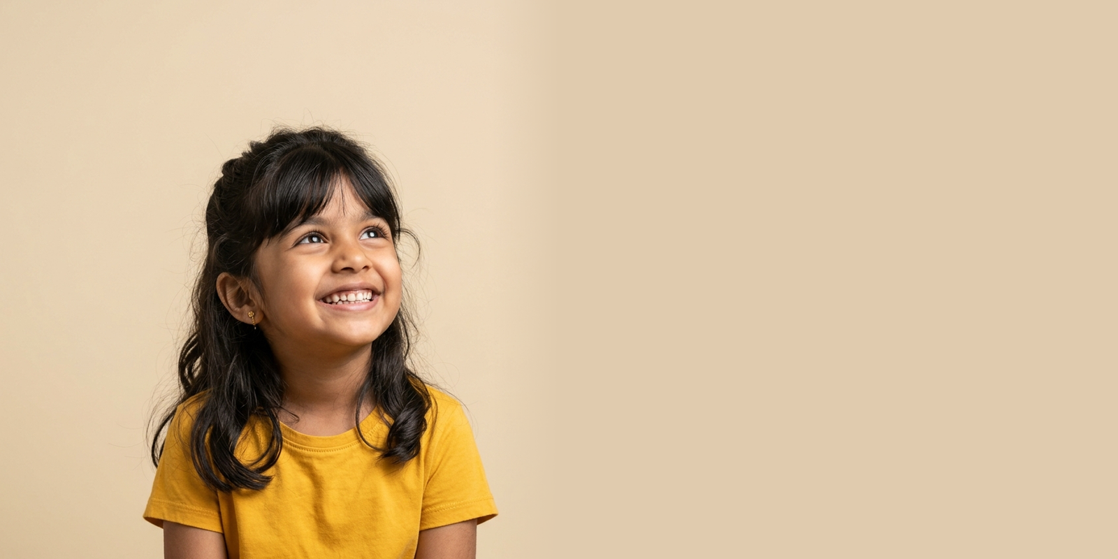 A smiling child looking ahead to the future
