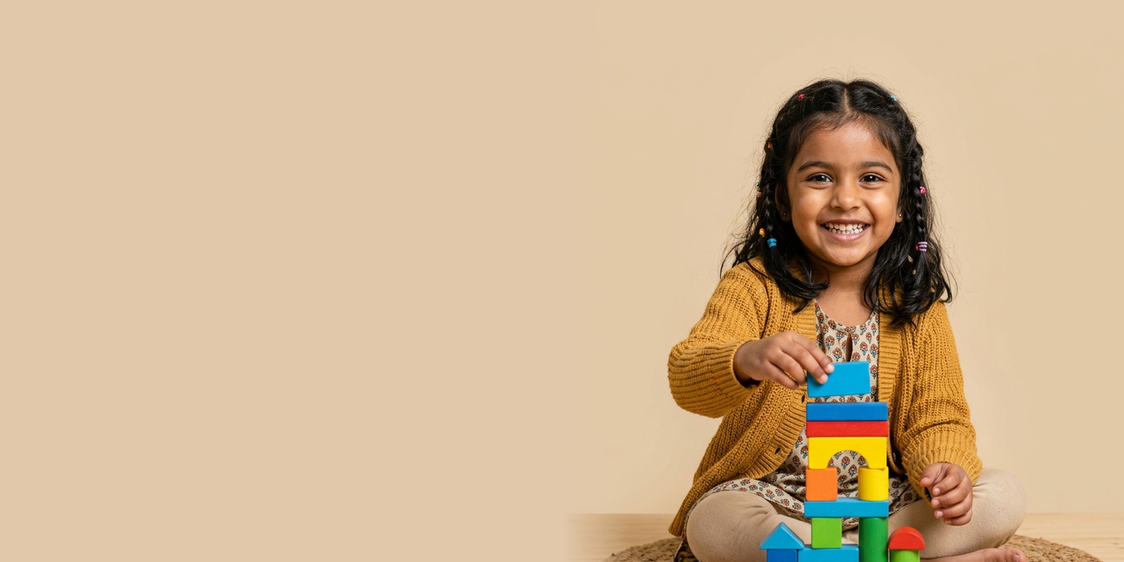 A child building with colorful wooden toy blocks